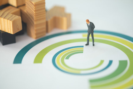 Miniature businessman standing on the circle chart paper and look at  chart for analyze data business. Business strategy conceptual photoの写真素材