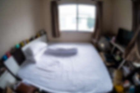 Defocused image of empty white bed at home. Photo taken with fisheye lensの写真素材