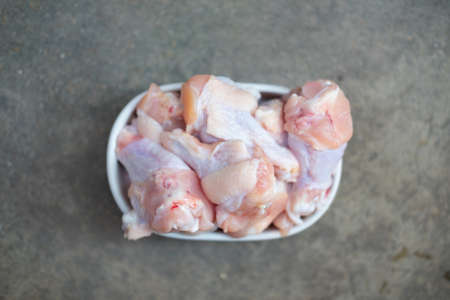 Raw chicken drumsticks on white plate for cooking. Thai foodの写真素材