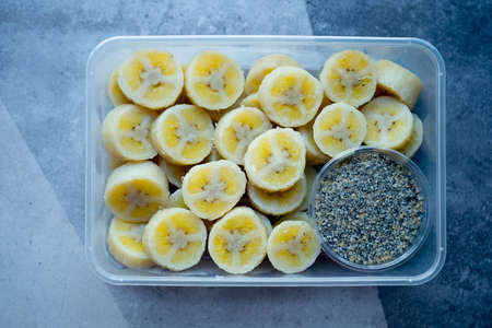 Delicious boiled banana served with black sesame mix sugar in box. Healthy snacks free of oil and fat, without seasonings and added ingredients.の写真素材