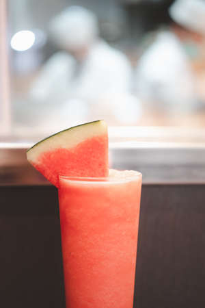 Red watermelon smoothie in a tall glass decorated with piece of watermelon. Healthy eco sweetの写真素材