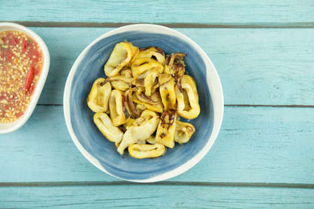 Grilled squid stuffed egg served with dressing Tha spicy sauceの写真素材