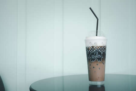 Bangkok - Thailand, April 11, 2021 : A plastic glass of iced Mocha coffee at cafe Punthai Brand, coffee is a famous coffee company in Thailand.のeditorial素材