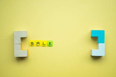 Sale word inside symbols left and right parentheses on a yellow background with copy-space. Concept holidays black friday, christmas, valentine's day and seasonal discountsの写真素材