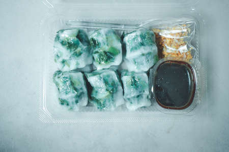 Steamed dumpling stuffed with garlic chives delicious with sweet black soy sauce and chili sauce in set boxの写真素材
