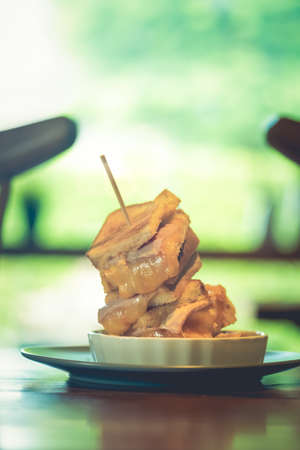 Pile of toasted bread sandwich with ham and cheese. Selective focus