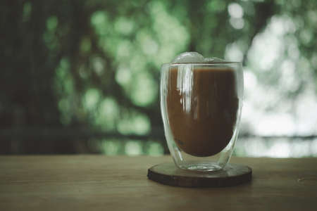 Iced mocha coffee served in the designed double-wall glass at coffee cafe. Look delicious, concept of coffee break time. Chilling and relax.の写真素材