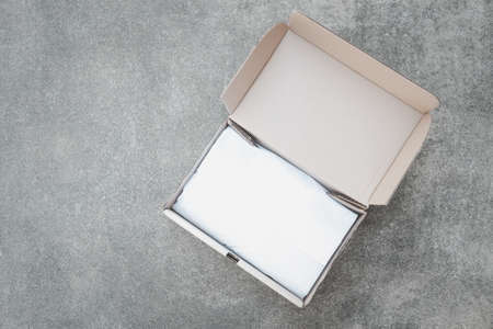 Open box from online shopping on cement background. One day delivery service.の写真素材