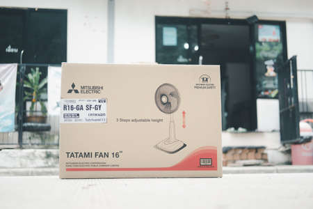Samut Prakan, Thailand - May 9, 2021 : Brown box with soft gray electric fan size of 16 inches...