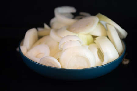 Sliced fresh white onions in ceramic bowl.の写真素材