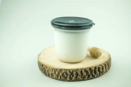 Fusion dessert made of tofu mix with milk to form jelly in cute package. Thai fusion dessert called Tao-Huay-Num-Sod place on wooden cutting boardの写真素材