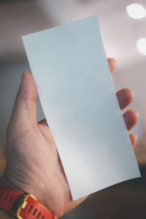 Man hand holding of empty bill receipt grocery shopping list of supermarketの写真素材