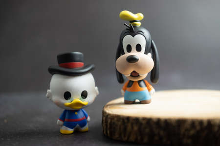 Samut Prakan, Thailand - May 20, 2021 : Cute figurine Goofy and Scrooge McDuck, collection figurine mickey mouse family figure in blind box at Miniso shopのeditorial素材