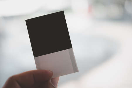 Man hand holding up a movie ticket. Blank template of ticket for your own design.の写真素材
