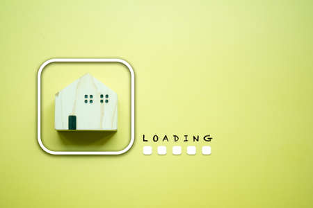 Wood home and loading progress bar icon on a yellow background. The concept of completed buy or move...