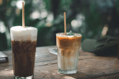 Selective focuson iced latte coffee and iced mocha on wooden table. Summer cold refreshing drink conceptの写真素材