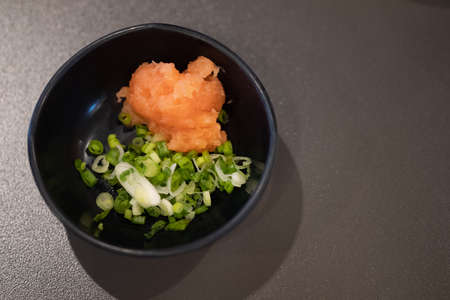 Top view of orange grated radish and scallion in mini bowlの写真素材