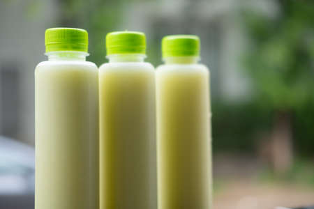 Fresh guava juice in plastic bottle against nature backgroundの写真素材