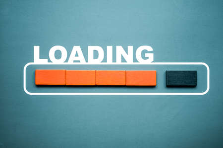 Loading bar with wood stick cube on pastel background. Wooden stick blocks with the word LOADING in...