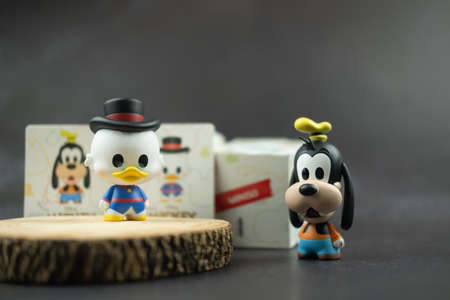 Samut Prakan, Thailand - May 31, 2021 : Cute figurine Goofy and Scrooge McDuck (Mickey Mouse Family Figure Blind Box Collection) new collections from Miniso shopのeditorial素材