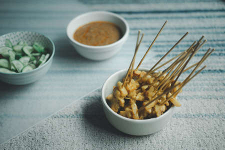 Grilled pork satay served with peanut sauce or sweet and sour sauce. Thai food