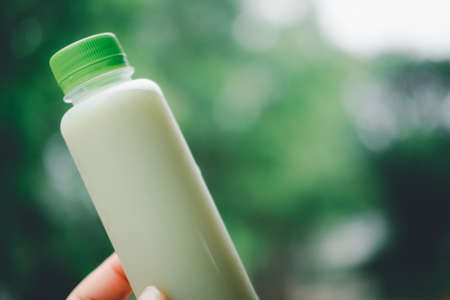 Guava fruit juice in plastic bottle against nature background.の写真素材