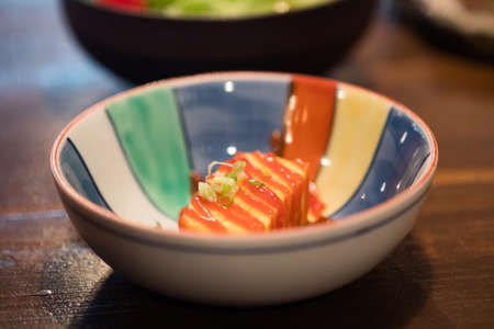 Tamagoyaki, Japanese sweet omelette pour with chili sauce, selective focus.の写真素材