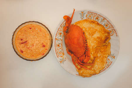 A big of steamed crabs placed on traditional Thai omelet served with seafood spicy sauce. Homemade foodの写真素材