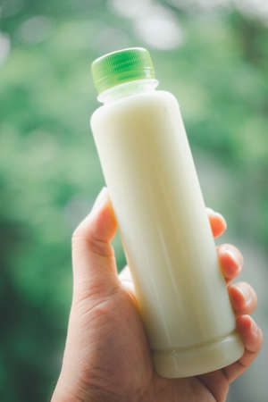 Chilled guava juice bottles on man hand. Close upの写真素材