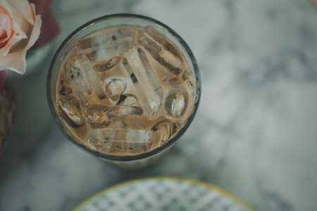 Cup of iced Mocha coffee on table, top view
