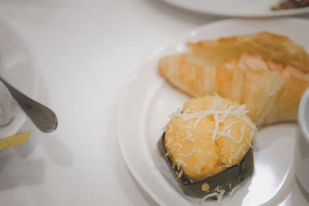 Toddy palm cake served with croissant white dish for break in meetingの写真素材