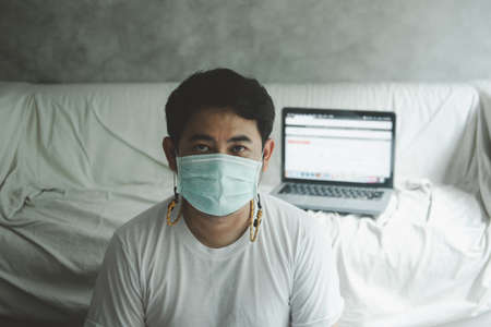Young man wearing hygienic mask to prevent infection,     Pandemic   quarantine period concept.