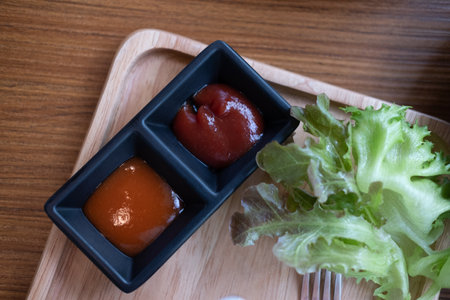 Chili sauce and ketchup in a mini tray. Top viewの写真素材