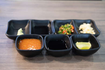 Set of chopped garlic and chili seasoning for topping sauce in shabu or sukiyaki hot potの写真素材