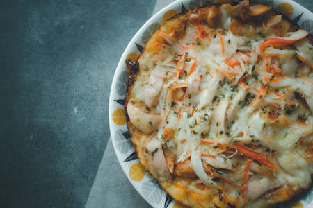 Tasty hot homemade pizza with hotdog and crab sticks with cheese. Pizzeria menu homemade by mom in during quarantine. Top viewの写真素材