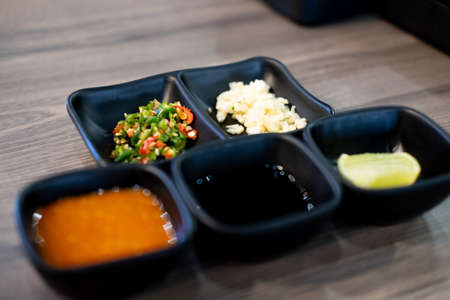 Set of chopped garlic and chili seasoning for topping sauce in shabu or sukiyaki hot potの写真素材