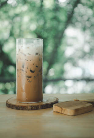 A glass of ice coffee with milk on the table refreshing cold drink. Another summer drink menuの写真素材