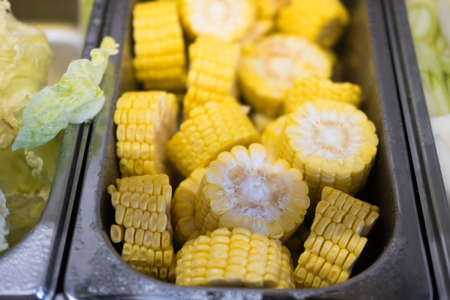 Raw cut of cron place in a metal tray ingredients prepared for the shabu shabu buffet of the...