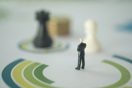 Miniature people standing and looking at blur background of chess. Money, Financial, Business Growth...