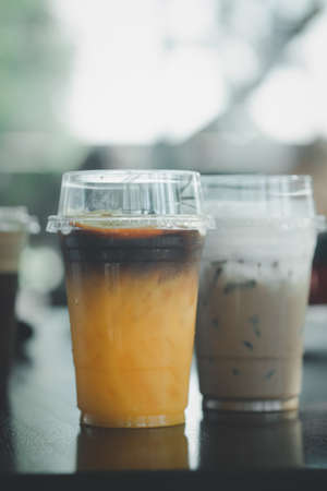 Iced black coffee mix orange juice and iced latte at cafeの写真素材