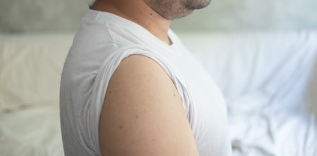 A man rolls up sleeves to be vaccinated against the coronavirus. Open arms receive covid-19...