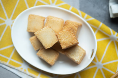 Close up of diced fish tofu on white dishの写真素材