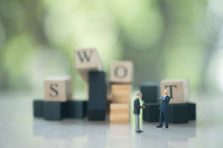 Businessman figures meeting brainstorm or talk, discuss about a company strategy with of SWOTの写真素材