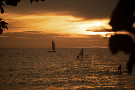 Silhouette of sailboat with sunset time in Thailandの写真素材