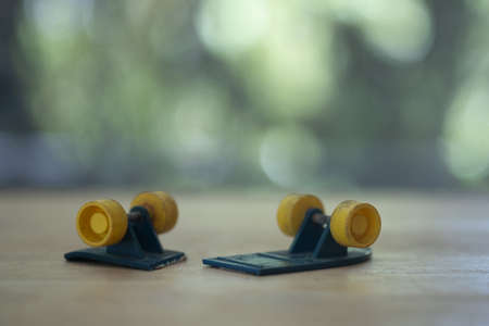 Old toy broke in half skateboard placed on wood tableの写真素材