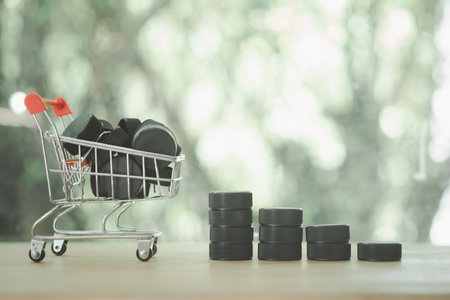Black plastic bottle caps in a shopping trolley on a nature background and black plastic bottle caps...
