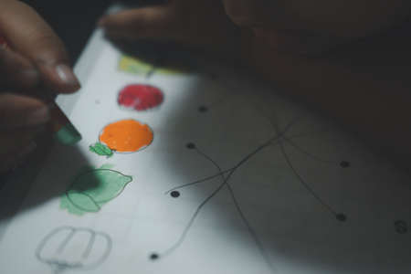 Close up of boy coloring on paper. Closeup and selective focusの写真素材