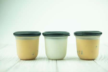 Fresh tofu milk pudding dessert in packaging, milk flavor and Thai milk tea flavor, close upの写真素材