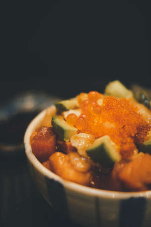 Japanese rice bowl with sashimi seafood on top. Selective focus pointの写真素材