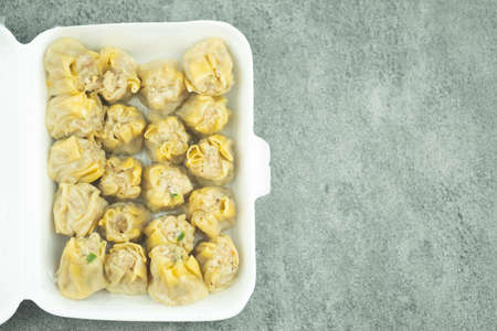 Pork dumpling in box, traditional fast food, sold in restaurant, market and street food.